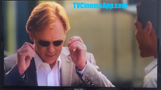 TVCinemaApp.com - CSI Miami: Horatio Caine (David Stephen Caruso) putting the eyeglasses Eric Delko (Adam Rodriguez) has brought for him as a gift on.