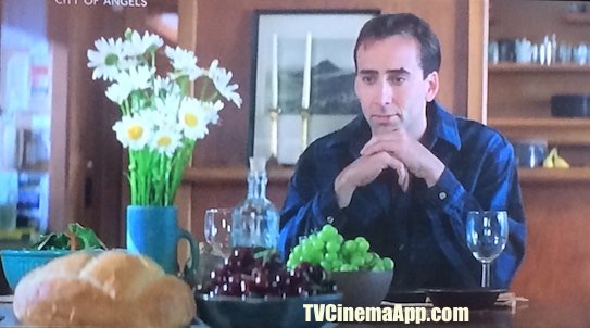 TV Cinema Gallery: Brad Silberling’s City of Angels, angel Seth (Nicolas Cage) in front of food trying to figure out what these things around him are and what they are for.